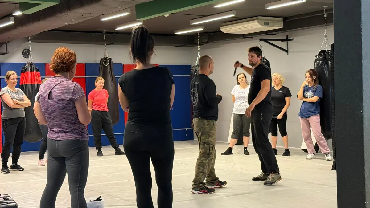 Women learning practical self-defence in a group workshop